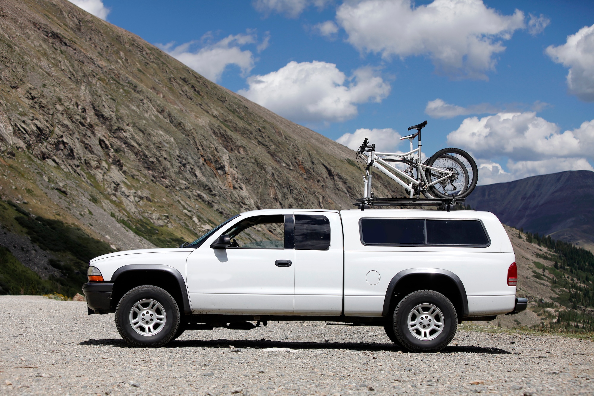 Image of a a couple of ford trucks by a lake