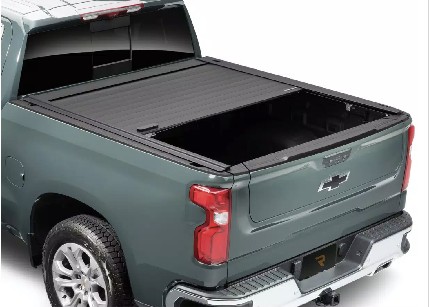 Image of a red Ford Raptor with a roll up bed cover to protect from the elements