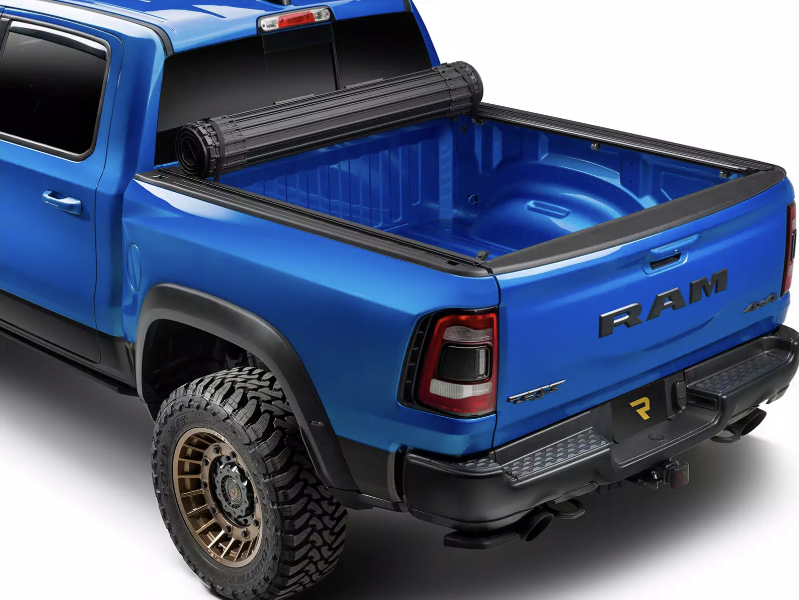 Image of a red Ford Raptor with a roll up bed cover to protect from the elements